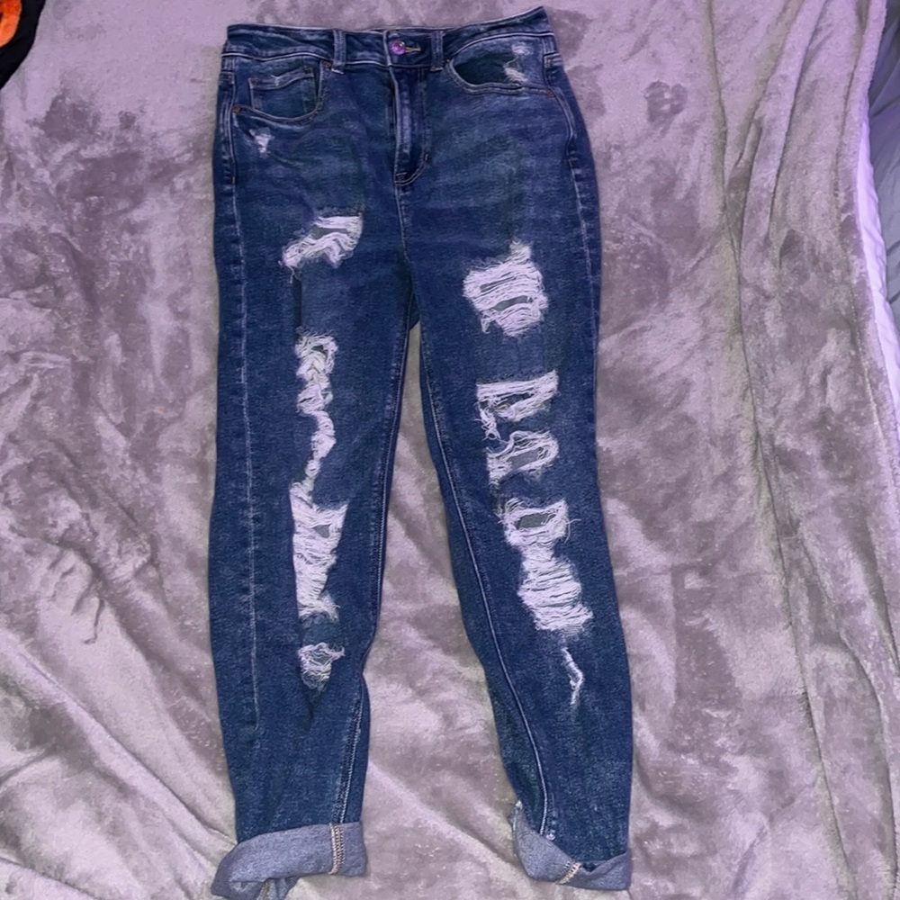 Women’s ripped blue American eagle jeans.